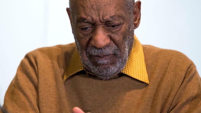 Entertainer Bill Cosby pauses during a news conference. Cosby's attorney said Sunday, Nov. 16, 2014 that Cosby will not dignify "decade-old, discredited" claims of sexual abuse with a response.