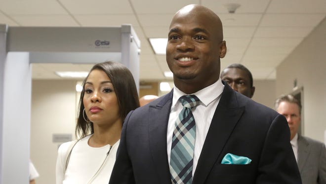 Minnesota Vikings running back Adrian Peterson leaves the courthouse with his wife, Ashley Brown Peterson, Tuesday in Conroe, Texas. Adrian Peterson avoided jail time in a plea agreement reached with prosecutors to resolve his child abuse case.