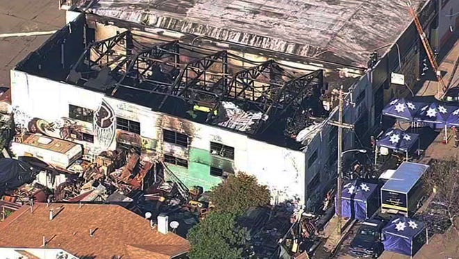 FILE- This Dec. 3, 2016 file image from video provided by KGO-TV shows the Ghost Ship Warehouse after a fire swept through the Oakland, Calif., building. More than six months after the Dec. 2 blaze at the warehouse that authorities said was illegally converted into living quarters, the Oakland Fire Department has released a 50-page report filled with harrowing details of death and panic as the flames and deadly smoke spread. The report contains many previously unknown details about the nation's deadliest structure fire in more than 14 years and says investigators could not determine the cause of the blaze due to extensive fire damage. (KGO-TV via AP, File)