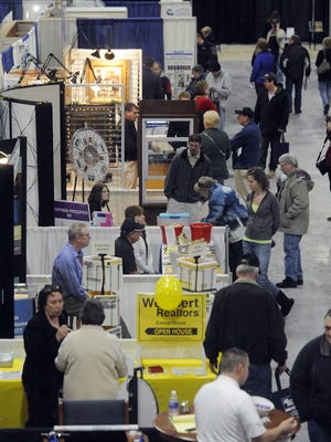 Visitors check out the vendor booths during the 2015 Manitowoc County Home Builders Association annual Home Show at the Manitowoc County Ice Center in Manitowoc.