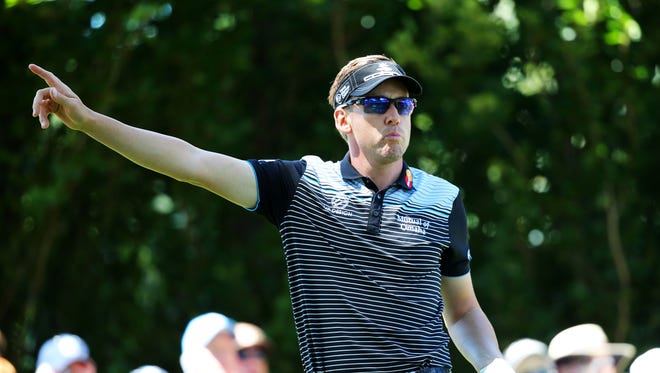 Ian Poulter of England signals after his tee shot on No. 10 flies wild.