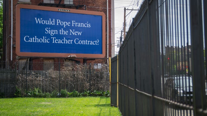 A billboard on the corner of Elm and West Liberty streets in May 2014 protests the Cincinnati Archdiocese contract for Catholic school teachers.