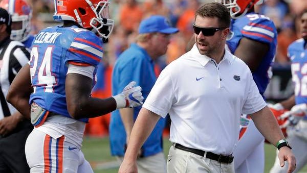 Florida's Nick Savage, right, director of football strength and conditioning, talks with running back Iverson Clement (24) during an NCAA spring college football intrasquad game, Saturday, April 14, 2018, in Gainesville, Fla. (AP Photo/John Raoux)
