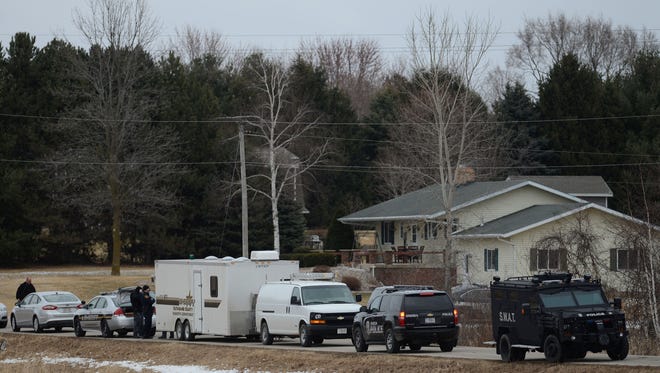 Various law enforcement agencies respond to a situation on Mullen Drive in Oneida, Wis. on Thursday, March 26, 2015.