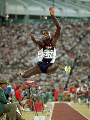In this July 29, 1996 photo, Carl Lewis takes his third jump during the men's long jump final at the 1996 Summer Olympic games in Atlanta. Lewis won the gold medal.