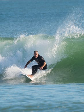 "This is almost like a surfer's church," said Charles Williams, founder and maker of Impact surfboards, after a Sunday morning surf on Nov. 19, 2017 at Fort Pierce Inlet State Park on North Hutchinson Island. Williams started surfing at the age of 14 and since then has prioritized time in the water. "My dad used to say 'every time opportunity comes knocking at your door, you're at the beach.'" Williams now produces 300-500 Impact surfboards per year, his flexible schedule allowing him to surf "when the tides are right."