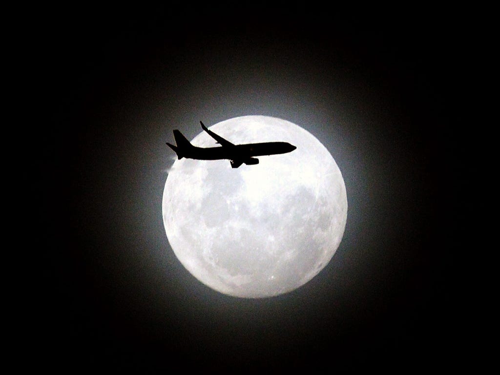 A passenger aircraft flies in front of the third and final perigree moon for the year over Maroubra Beach in Sydney, Australia.The event is the result of a full moon closer to the earth than usual and also coincides with the Geminid Meteor Shower, an