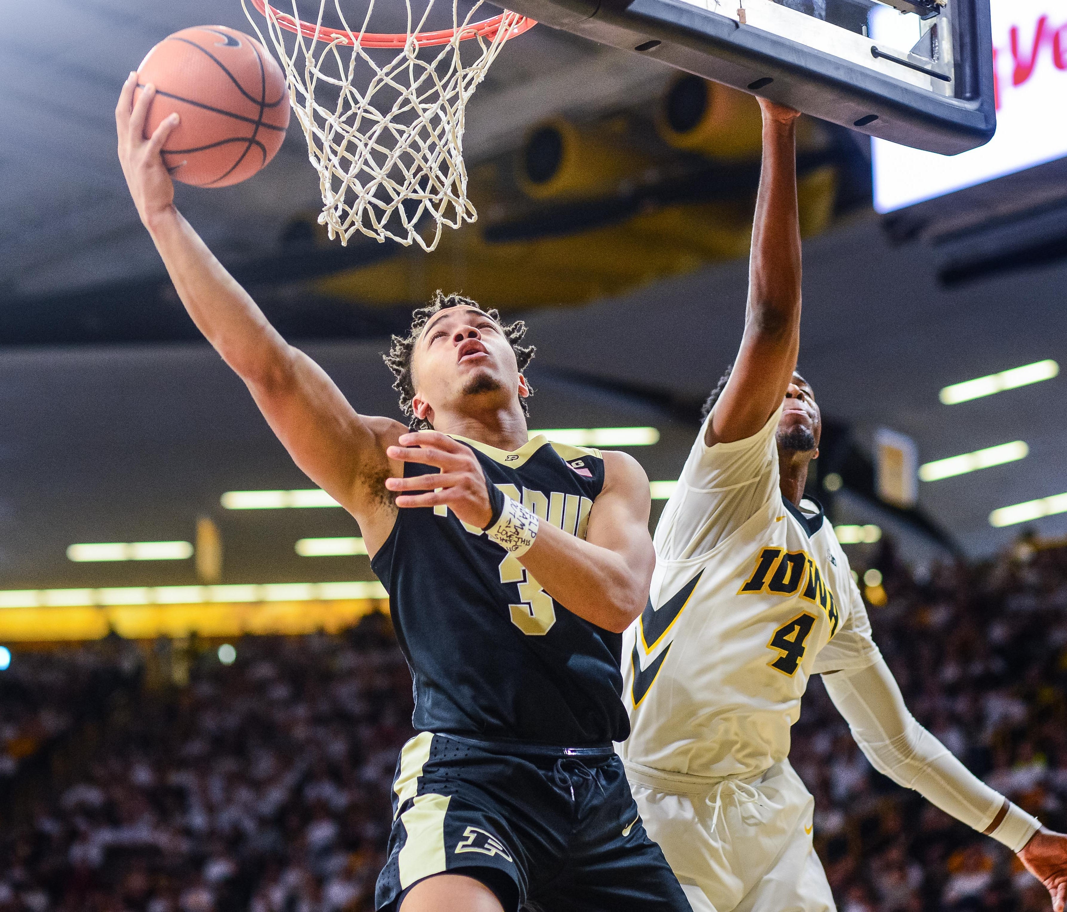 Purdue Boilermakers guard Carsen Edwards (3) goes to the basket as Iowa Hawkeyes guard Isaiah Moss (4) defends during the first half at Carver-Hawkeye Arena.