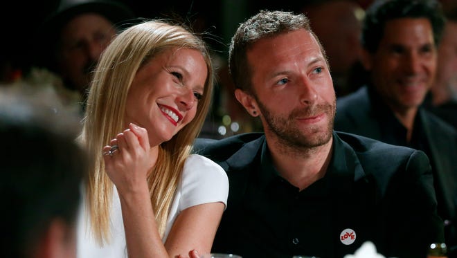 This Jan. 11, 2014 file photo shows actress Gwyneth Paltrow, left, and her husband, singer Chris Martin in Beverly Hills, Calif.