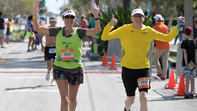 Runners cross the finish line during the Marathon of the Treasure Coast on Sunday, March 5, 2017, in Stuart.