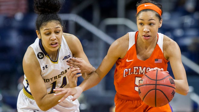 Clemson's Danielle Edwards (5) drives next to Notre Dame's Mychal Johnson (14) during the first half of an NCAA college basketball game Thursday, Feb. 25, 2016, in South Bend, Ind. (AP Photo/Robert Franklin)