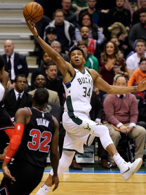 Bucks forward Giannis Antetokounmpo intercepts a pass during the first half Tuesday night against the Bulls.