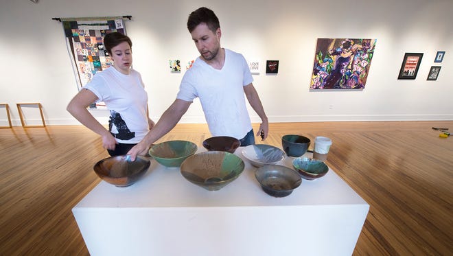 Ivy Rodgers, a fellow at Marketview Arts, left, and Matt Apol, work with pottery made by Alex Pottinger, '07, while preparing for The Alumni Art Exhibition, Selected New Works by YCP Art Division Alumni at Marketview Arts at 37 W. Philadelphia Street in York Wednesday January 4, 2017. . The show runs from January 6-27.