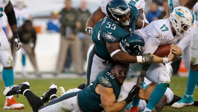 Miami Dolphins' Ryan Tannehill (17) is tackled by Philadelphia Eagles' Connor Barwin (98) and Brandon Graham (55) during the second half of an NFL football game, Sunday, Nov. 15, 2015, in Philadelphia.