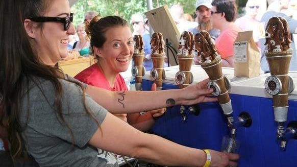 A Happy Basset Brewing Co. worker smiles during the 2018 Tap That Topeka. This year's festival has been canceled because of COVID-19.