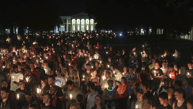 University of Virginia students, faculty and residents attend a candle light march across grounds in Charlottesville on Wednesday. Hundreds gathered on the campus for a candlelight vigil against hate and violence days after Charlottesville erupted in chaos during a white nationalist rally.