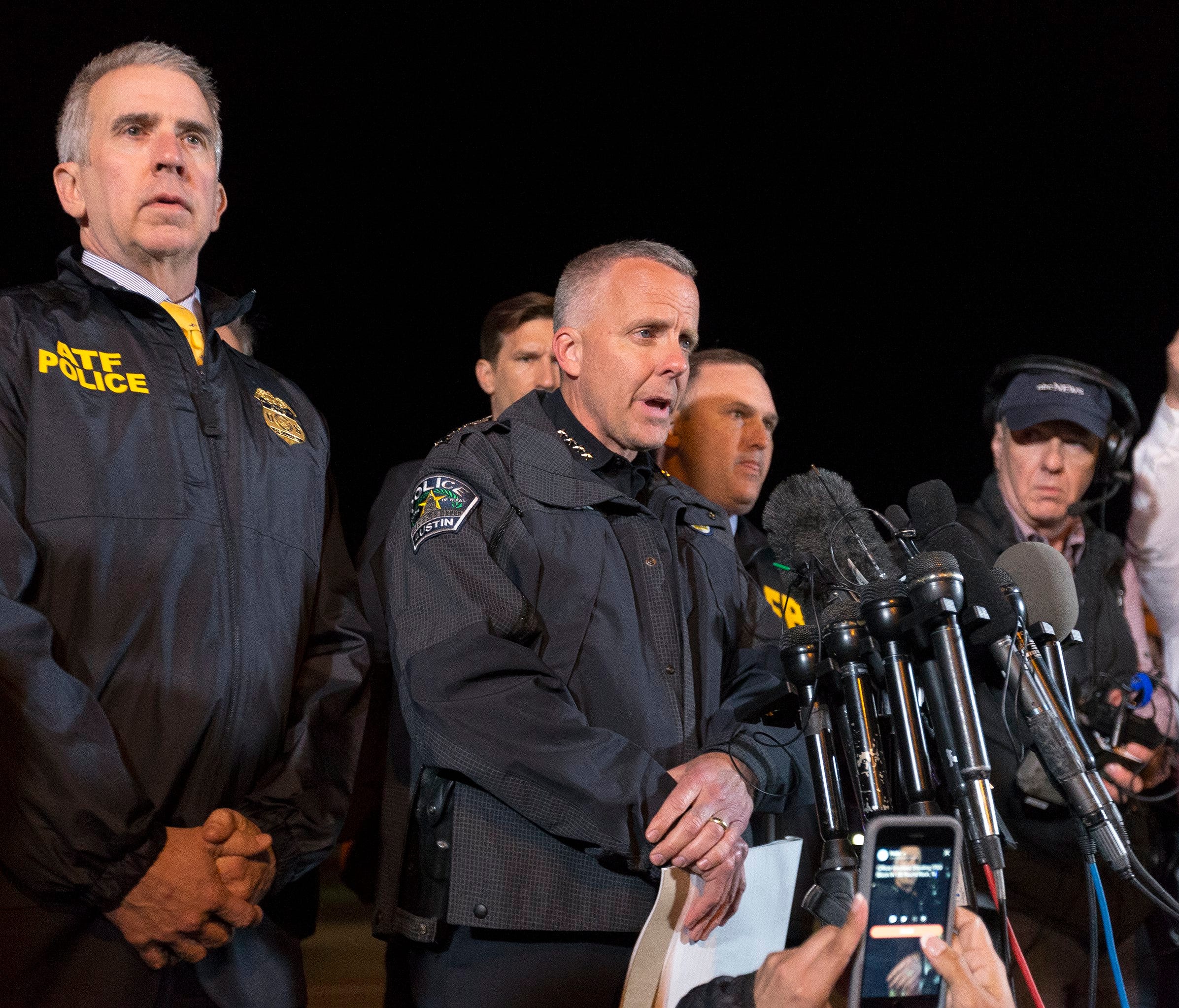 ATF Agent in Charge Fred Milanowski, left, and Interim Austin Police Chief Brian Manley, speak to the media as law enforcement investigates the scene where a bombing suspect allegedly blew himself up after being confronted by police in Round Rock, Te