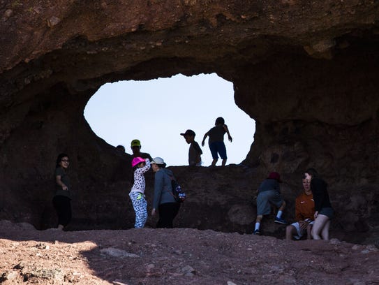 People explore Hole in the Rock at Papago Park in Phoenix,