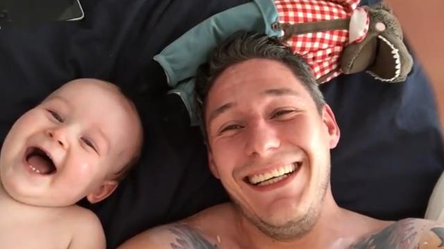 Baby can't stop laughing at goofy dad