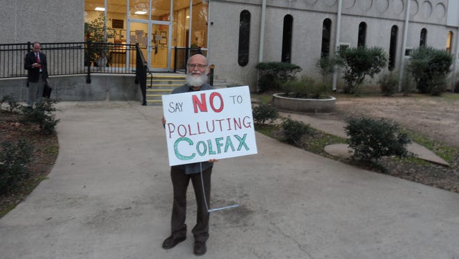 Ron Hagar of Shreveport stands in front of the Grant Parish Courthouse in Colfax on Thursday holding a sign that reads "Say No To Polluting Colfax." The Grant Parish Police later voted to oppose a company's plan to increase the amount of hazardous wastes that it burns.