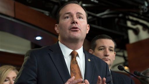 FILE - In this Feb. 12, 2015 file photo, Sen. Mike Lee, R-Utah, accompanied by Republican Presidential candidate, Sen. Ted Cruz, R-Texas, speaks during a news conference on Capitol Hill in Washington, Congress’ debate over domestic surveillance is scrambling partisan divisions in the Senate as libertarian-minded Republicans defy their leaders to make common cause with liberal Democrats.  (AP Photo/Molly Riley, File)