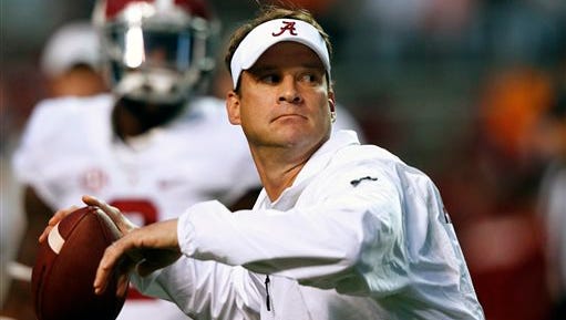 Alabama offensive coordinator Lane Kiffin throws during warmups before an NCAA college football game against Tennessee, Saturday, Oct. 25, 2014 in Knoxville, Tenn. (AP Photo/Wade Payne)