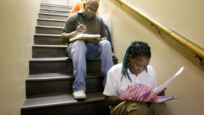 September 13, 2016- Jesse Thomas and Ashley Smith find a quiet stairwell to fill out applications during a September  job fair held by the Church of God in Christ of Memphis. Expansions such as the project in Memphis planned by International Distributors has pushed the jobless rate down to 5.5 percent.