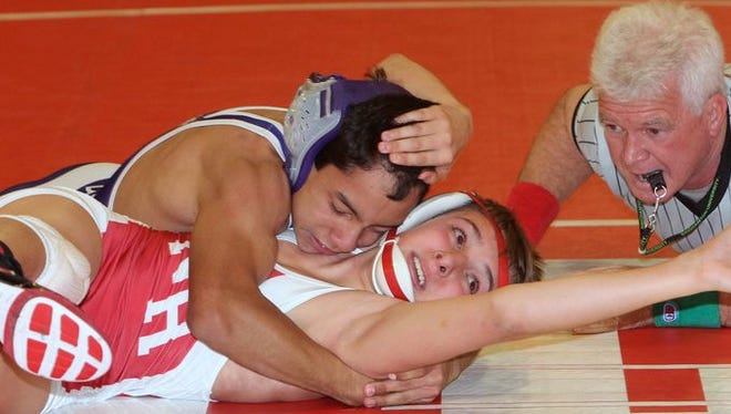 North Rockland's CJ McMonegal, bottom, escaped from this near pin to defeat New Rochelle's Joey Rodas, 8-7, in their 106-pound match of the Division 1 quarterfinals of the Section 1 Dual Meet Championships at North Rockland Dec. 8, 2015. North Rockland won 46-17.