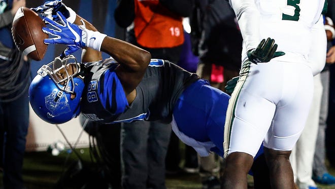 University of Memphis receiver Phil Mayhue can not make a make a touchdown catch against the University of South Florida defense during fourth quarter action at the Liberty Bowl Memorial Stadium. 