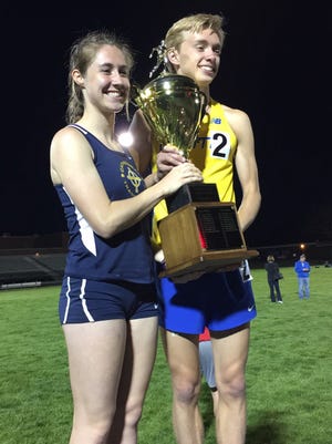 Miracle Mile champions Katherine Free of Cathedral and Ben Veatch of Carmel hold the race trophy.