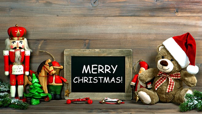 Christmas decoration with antique toys and blackboard. Vintage style toned picture with sample text Merry Christmas