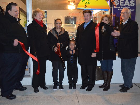 A ribbon cutting was held on Third Thursday at Touch of the Caribbean, 10 Central Ave., Hammonton. The eatery, owned by Rosa Esteras of Hammonton, offers traditional Caribbean favorites. Pictured from left are Mayor Steve DiDonato, Cassie Iacovelli, executive director of Hammonton MainStreet; owner Rosa Esteras; her grandson, Aarron Williams, 4, of Hammonton; Benjamin Ott, president of MainStreet Hammonton; Kathy Buckman, chair of the Economic Restructuring Committee of MainStreet Hammonton; and John Runfolo, executive director of the Greater Hammonton Chamber of Commerce.