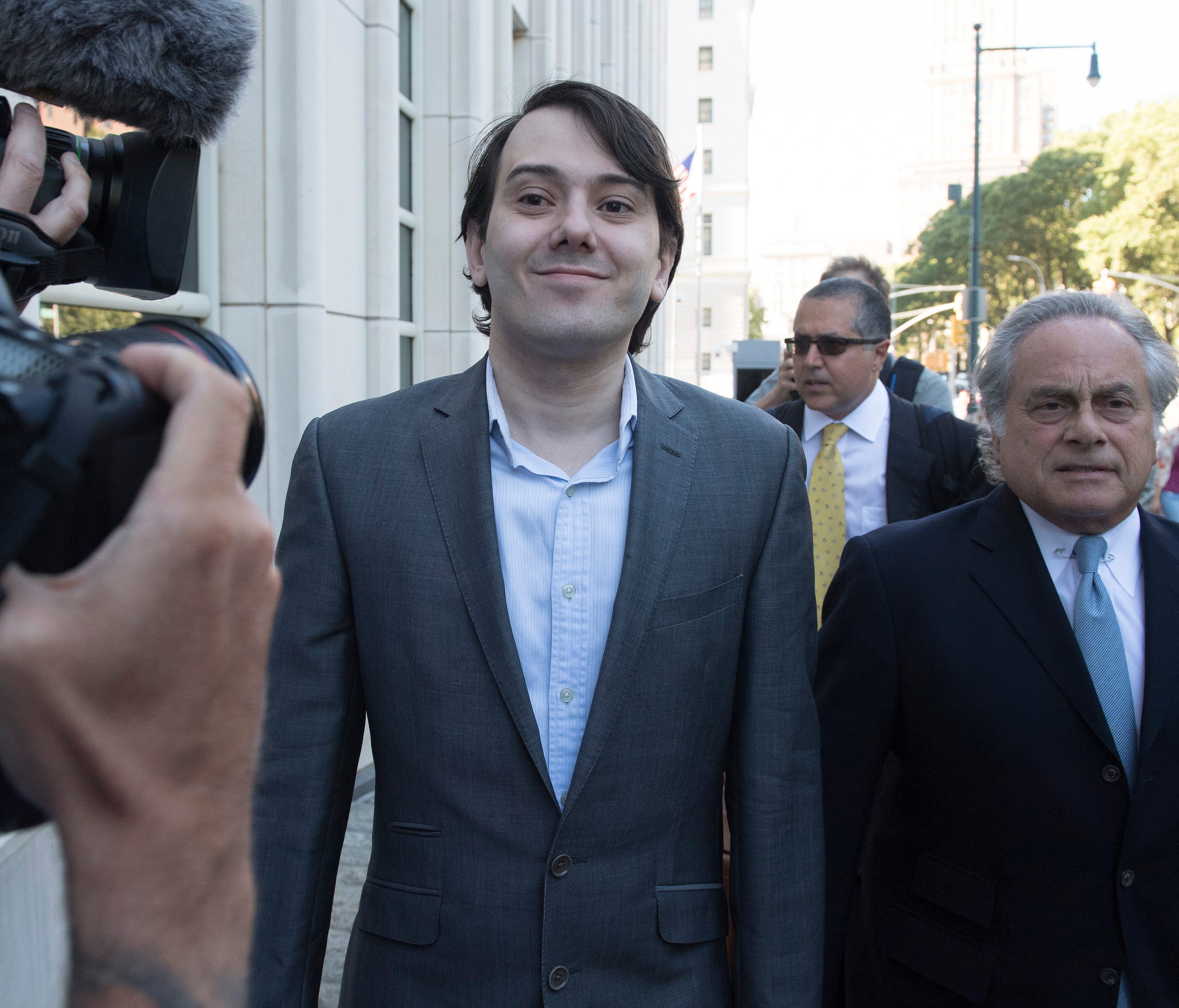 File photo shows pharmaceutical industry entrepreneur Martin Shkreli, center, arriving with defense lawyer Benjamin Brafman at Brooklyn federal court in New York City.