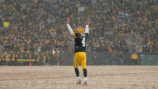 Green Bay Packers quarterback Brett Favre celebrates after a touchdown during the Jan. 12, 2008, playoff game against the Seattle Seahawks. The Packers are scheduled to unveil Favre's name and No. 4 on the facade of Lambeau Field during the Thanksgiving Day game.