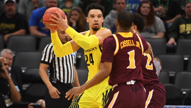 Mar 17, 2017; Sacramento, CA, USA; Oregon Ducks forward Dillon Brooks (24) controls the ball as Iona Gaels guard E.J. Crawford (2) and Gaels guard Sam Cassell Jr. (1) defend during the first half in the first round of the 2017 NCAA Tournament at Golden 1 Center. Mandatory Credit: Kyle Terada-USA TODAY Sports