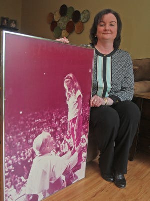 Geralyn Smith of Bardonia was 6 years old when she was pulled from the crowd at Madison Square Garden and presented to Pope John Paul II on Oct. 3, 1979. Smith, was photographed April 28, 2014 with a photo taken of her standing on the Popemobile meeting John Paul II.