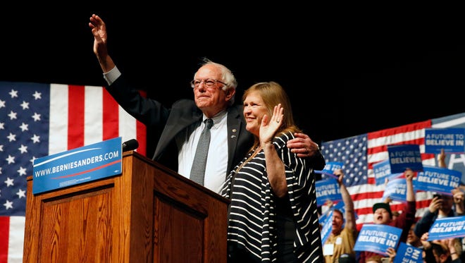 Bernie Sanders and his wife, Jane, wave to supporters during his campaign rally in Laramie, Wyo., on April 5, 2016.