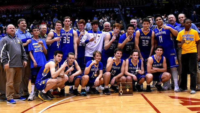 Madeira's Mustangs show off their medals and trophy after winning the Division III District Crown, March 7, 2018.