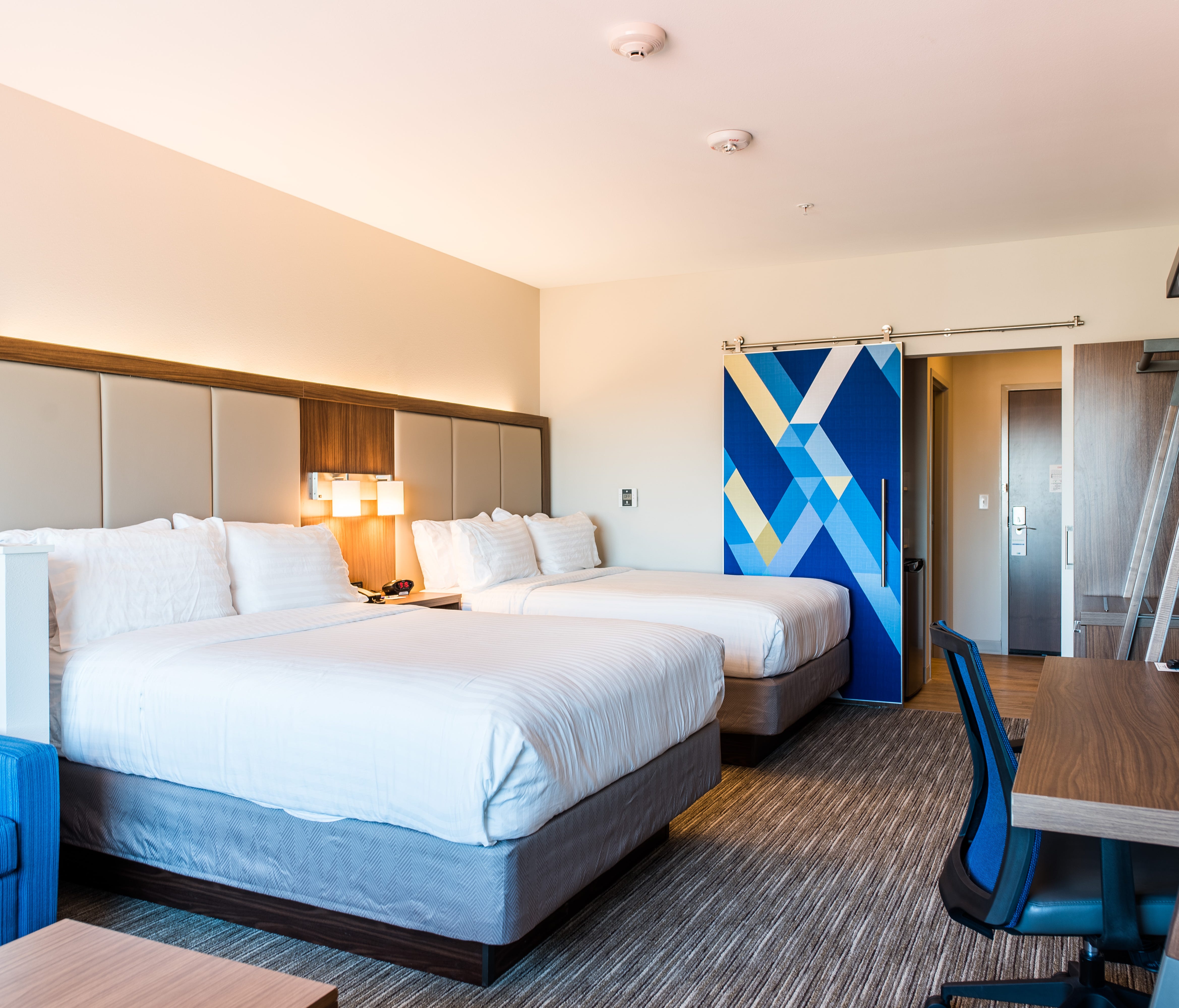 Rooms in select Holiday Inn Express hotels have sliding doors to separate the sleeping area from the entry and bathroom in order to promote sleep.