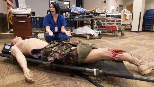 Lt. Sarah Bush describes the procedures and equipment medical personnel will use to train with while observing National Patient Safety Week at Pensacola Naval Hospital.