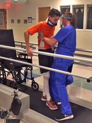 Alex Kingsbury starts to practice walking during physical therapy at Riley Hospital for Children at IU Health, on the road to recovery from an October 2017 injury from a fall.  Alex was injured while tree parachuting.  He broke his neck and was paralyzed.  Doctors at Riley thought he would not walk again. But with quick emergency care, surgery, rehab, and Alex's hard work and perseverance, he can walk again.
