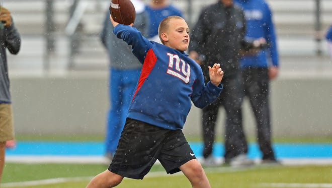 Tatum Marks, the son of former MTSU quarterback Clint Marks, celebrates his 10th birthday by throwing a pass during MTSU's spring finale at Floyd Stadium on April 14, 2018.
