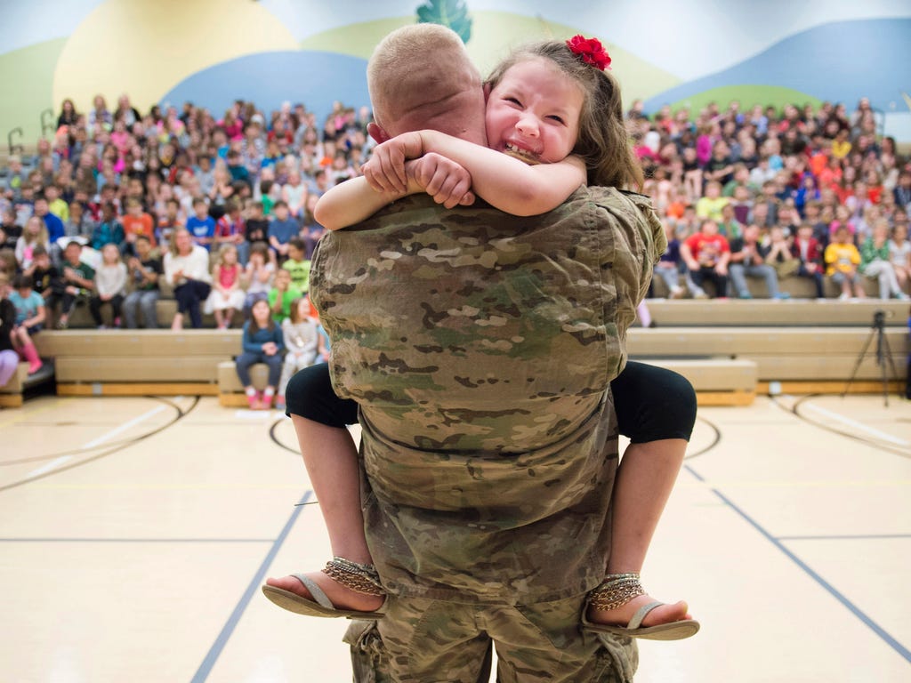 Second-grader Imogen Nowak cries in the arms of her father, U.S. Army Captain Erik Nowak, after he surprised her during an assembly March 28, 2017, for National Kindness Week at Quaker Valley's Osborne Elementary School in Sewickley, Pa. &n