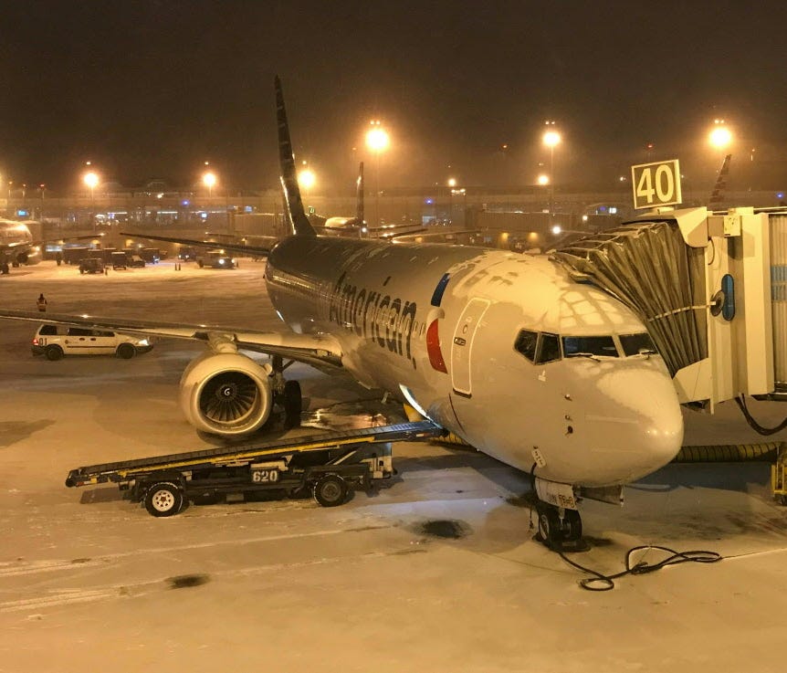 An American Airlines plane sits on the tarmac at Ronald Reagan airport, near Washington, DC, before departure January 4, 2018.  The US National Weather Service warned that a major winter storm would bring heavy snow and ice, from Florida in the southe