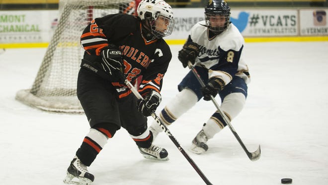 Middelbury's Angela Carone (22) passes the puck during the Division I high school girls hockey championship between the Middlebury Tigers and the Essex Hornets at Gutterson Fieldhouse on Tuesday night .