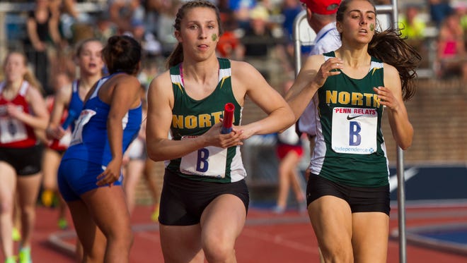 North Hunterdon's Gabrielle Beneducci takes a handoff from team mate Anna DiMarcello as they compete in High School Girls Distance Medley Relay in which they finished fourth on Thursday at Penn Relays in Philadelphia, Pa. on April 27, 2017.