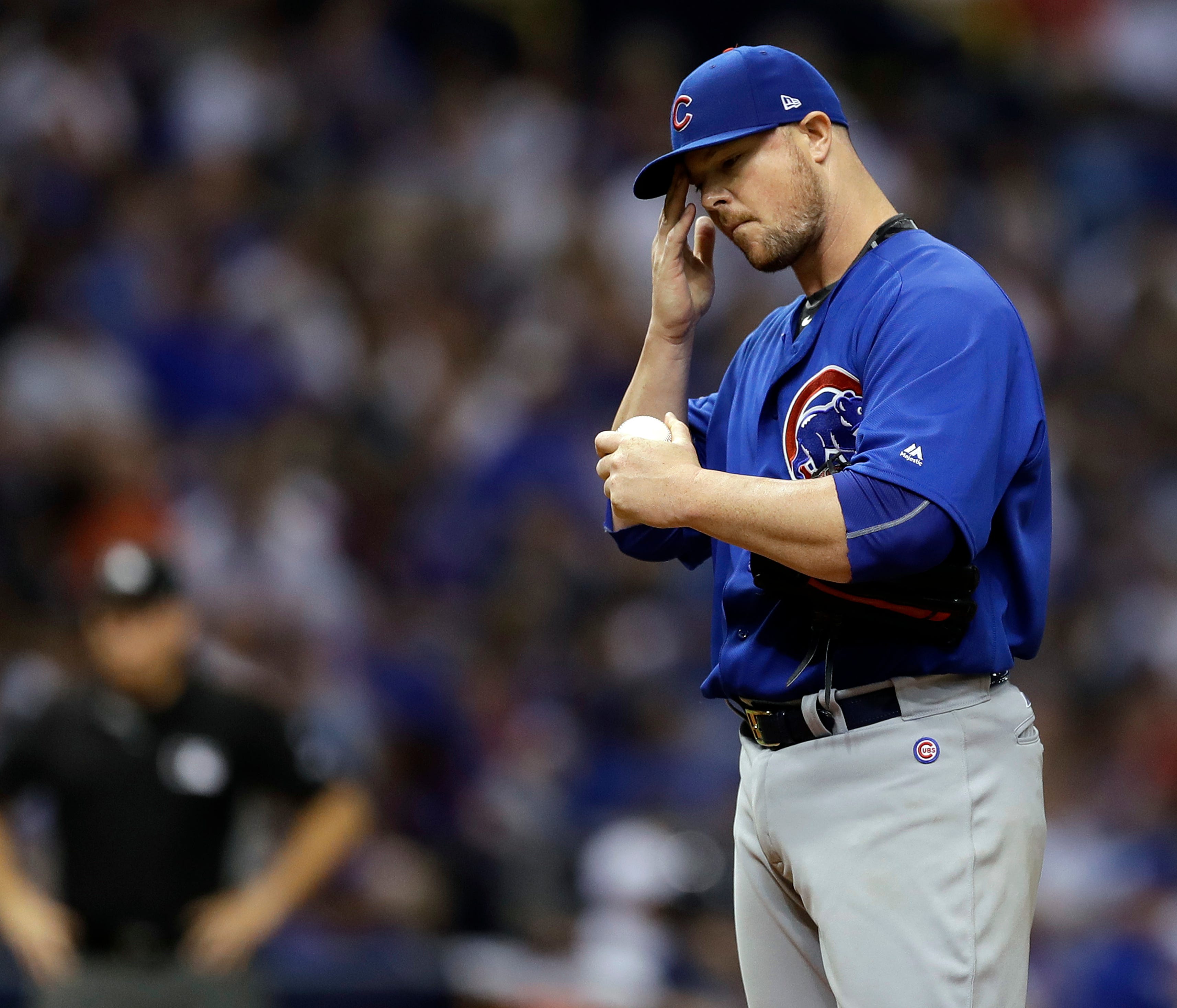 Chicago Cubs starting pitcher Jon Lester wipes his forehead as he struggles against the Tampa Bay Rays during the fifth inning of a baseball game Wednesday, Sept. 20, 2017, in St. Petersburg, Fla. Lester was removed later in the inning. (AP Photo/Chr