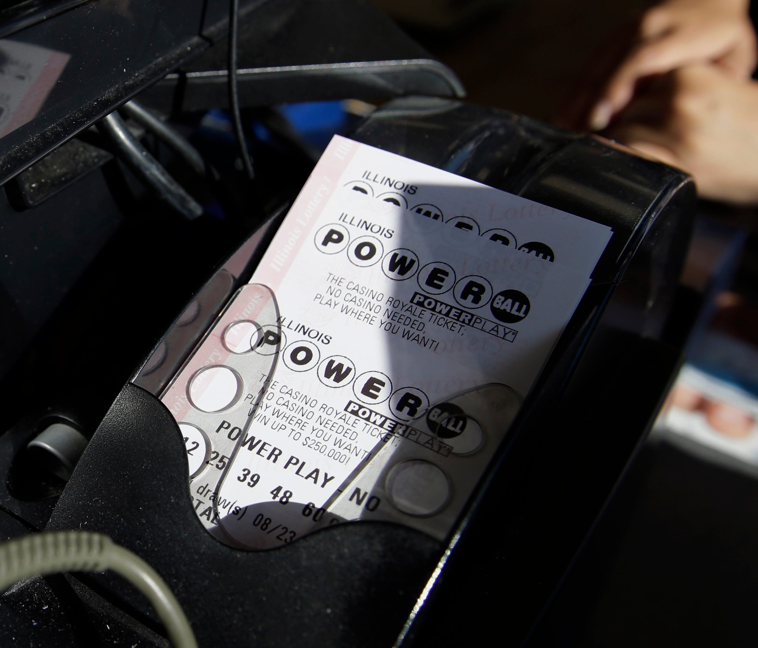 A Powerball lottery ticket is printed out of a lottery machine at a convenience store Aug. 23, 2017, in Northbrook, Ill.
