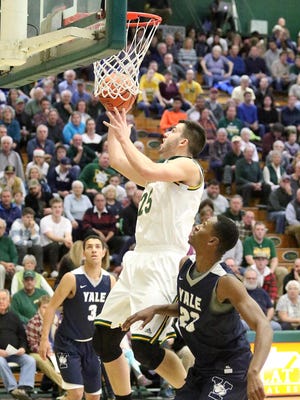 UVM junior Drew Urquhart puts in two points UVM during Vermont's 67-65 win over Yale at Patrick Gym.