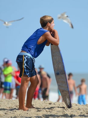 Jack Lee, Rehoboth, waits for the perfect wave during his heat in the semifinals of the Skim USA Association ZAP Pro/Am Skimboarding Competition in Dewey Beach, De. on Friday, August 11, 2017.
